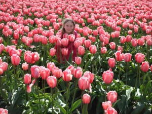 My beautiful granddaughter in a field of tulips north of Seattle Blue speaker icon symbolizing sound or volume.